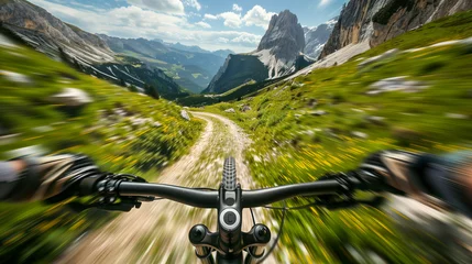 Tuinposter A person riding a sportive e-bike, is racing down a steep dirt road in a mountainous area. © Frank Gärtner
