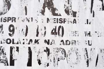 Torn and ripped street poster, abstract and grungy background with text and alphabet