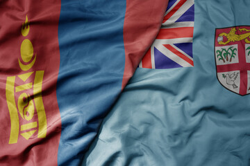 big waving national colorful flag of Fiji and national flag of mongolia.