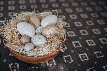 Easter eggs in a nest on a wooden background. Vintage style.