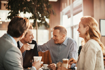 Business people having a meeting at an indoor cafe
