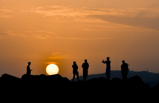 silhouette of people on sunset