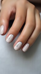Calm beauty delicate nail design with shiny gold stripes, beautiful female hands with well-groomed neutral manicure