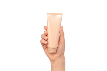 Beige cream tube in woman hands isolated on a white background.
