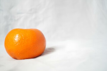A small orange on a white background