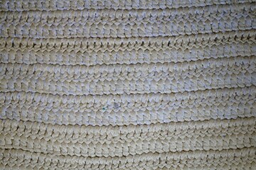 A white and tan rug with a pattern of white and brown