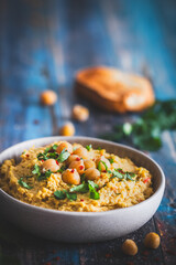Hummus, chickpea puree with coriander in a bowl