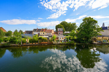 Houses built on the banks of the river Somme opposite the famous Hortillonnages of Amiens in...