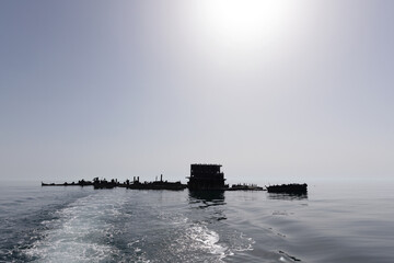 A submerged tugboat shipwreck around 8km in the eastern coast of Bahrain sea. - obrazy, fototapety, plakaty