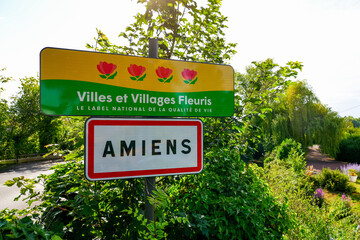 Road sign at the entrance of the city of Amiens in Picardy, labelled "Villes et Villages Fleuris", indicating this is one of the most flowery towns in France