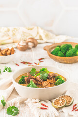 Tom Kha Gai soup with various vegetables and roasted chicken or soy-based meat substitutes