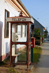 Stary telefon na monety w budce telefonicznej 