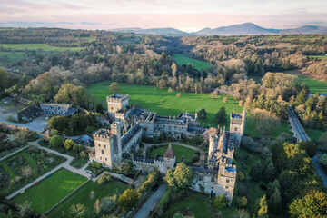 Aerial view of majestic Lismore Castle in County Waterford, Ireland, bathed in the golden glow of...