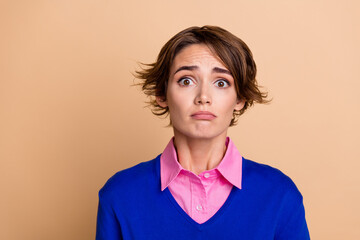 Photo of depressed upset woman wear blue pullover listening bad news empty space isolated beige...
