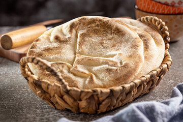 Pita bread on the table. Arabic lebnani bread.