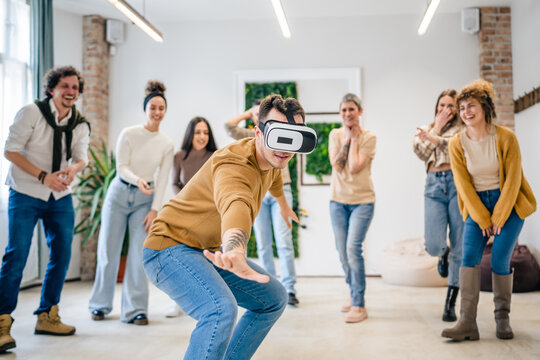 One man in front of group of friends enjoy virtual reality VR headset
