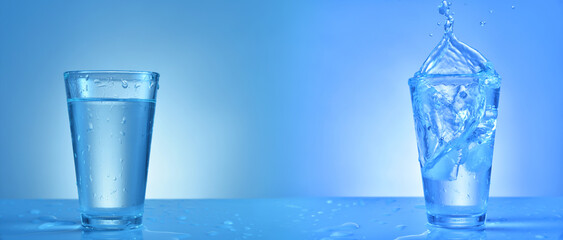 Glass of fresh water with splash on color background