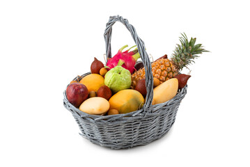 basket with tropical fruits isolated on white