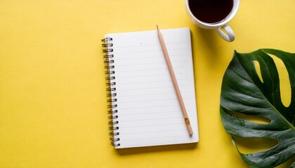 Fototapeta na wymiar top view of blank notebook on yellow background