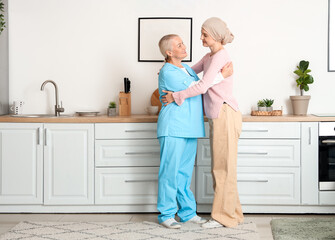 Young woman after chemotherapy hugging nurse at home. Stomach cancer concept