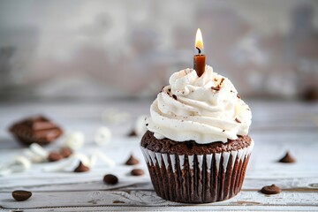 Chocolate cupcakes with whipped cream and candle on wooden table