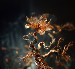 a beautiful sculpture of a flower made from copper wires 