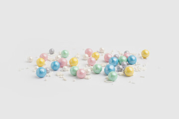 Sweet colorful sprinkles scattered on white background