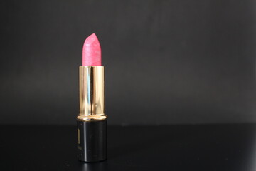 Pink lipstick in a black tube