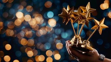 A hand gesture holding five golden star awards, representing success in business or the recognition of personal talent - obrazy, fototapety, plakaty