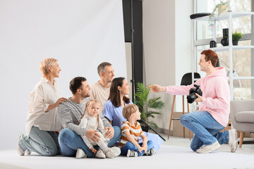 Male photographer working with big family in studio
