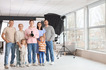 Male photographer with big family in photo studio