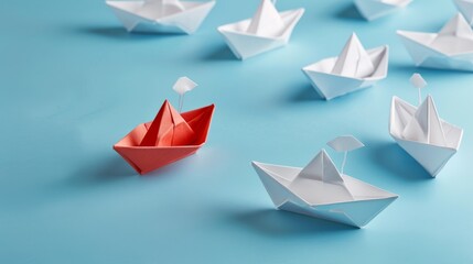 A visual metaphor for innovation and leadership, featuring a group of white paper ships with one red ship pointing in a different direction on a blue background