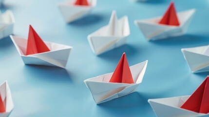 A visual metaphor for innovation and leadership, featuring a group of white paper ships with one red ship pointing in a different direction on a blue background