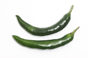 Two green hot chili pepper top view isolated on white background clipping path