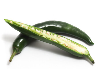 Half sliced green hot chili pepper isolated on white background clipping path