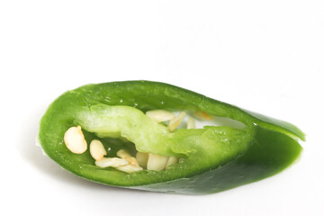 Close-up sliced green hot chili pepper top view isolated on white background clipping path