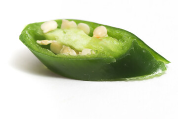 Close-up sliced green hot chili pepper isolated on white background clipping path