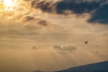 Seaplane flying at sunset hours