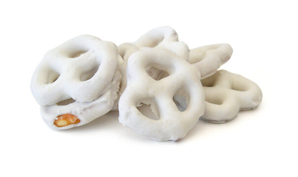 White chocolate covered pretzels on white background 