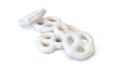 White chocolate covered pretzels on white background  - 763576086