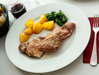 Delicious fried beef entrecote served with vegetable garnish of baked jalapeno and potatoes