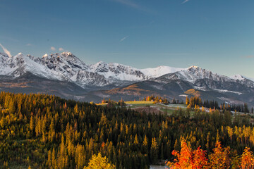 Autumn in the mountains. Sunrise in Gliczarow Górne with a view of the snow-covered Tatra...