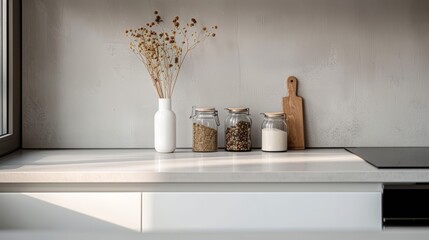 Minimalist kitchen interior with dried flowers in vase. Glass jars with spices on countertop