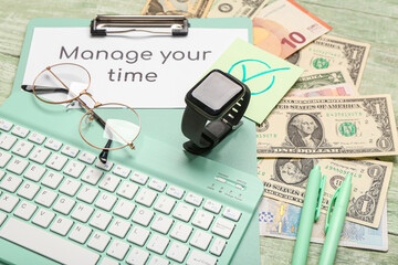 Composition with text MANAGE YOUR TIME, eyeglasses, money and smart watch on green wooden...