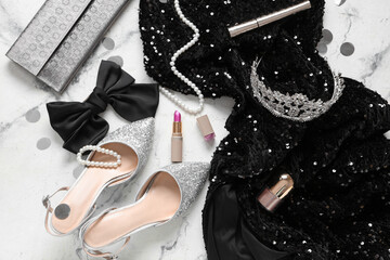 Female prom outfit with lipstick, tiara and clutch on white grunge background