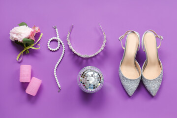 Female prom shoes with tiara, boutonniere and disco ball on purple background © Pixel-Shot