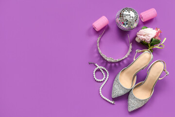 Female prom shoes with tiara, boutonniere and disco ball on purple background