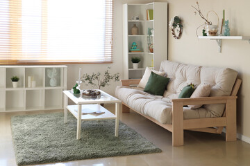 Interior of living room with sofa, shelf units and Easter decor