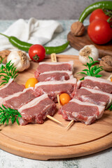 Lamb sirloin. Lamb sirloin meat skewered on a wooden serving board
