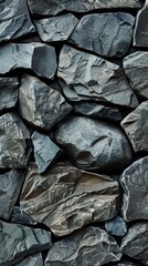 High-resolution close-up of dark slate stone pieces creating a natural textured surface